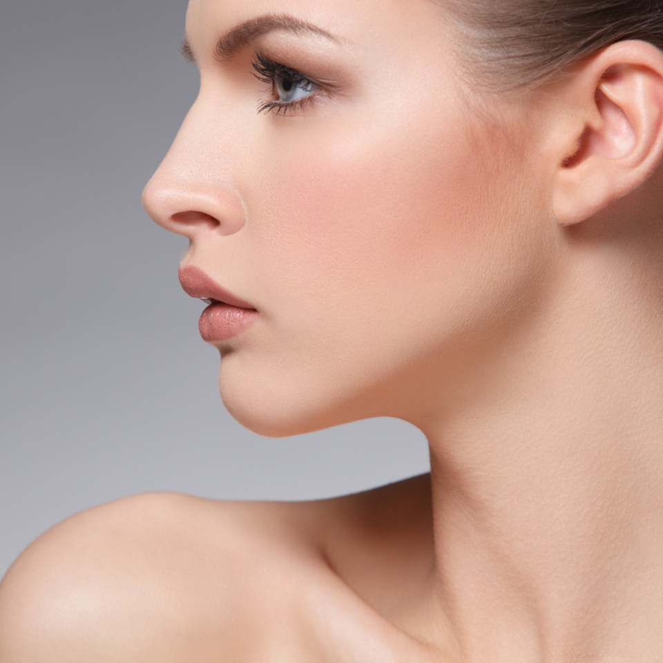 closeup portrait of beautiful female face over gray background