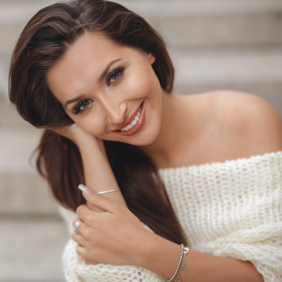 Portrait Of Young Smiling Beautiful Woman. Close-up portrait of a fresh and beautiful young fashion model posing outdoor. Summer outdoor portrait