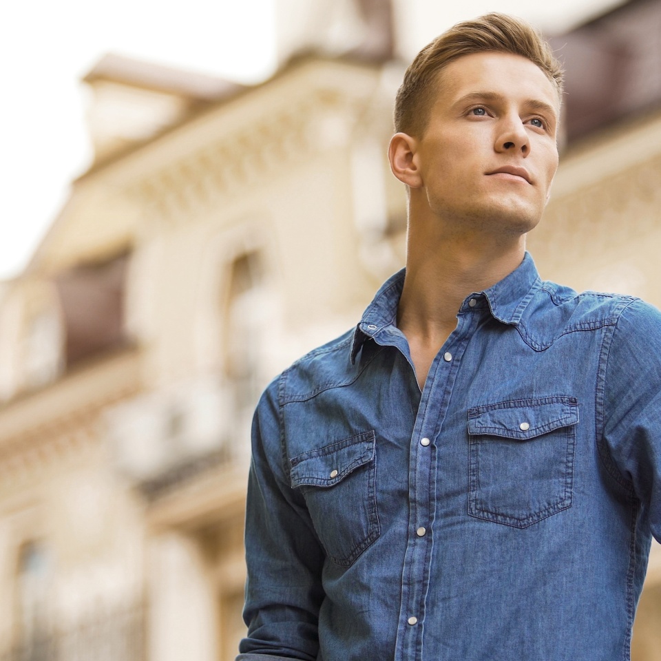 Handsome young man waiting for date, cute smiling guy looking into distance